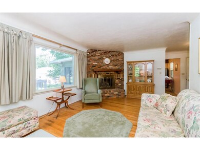 Wood floor in living room, with gas fireplace and 