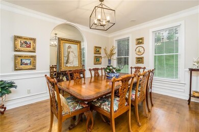 Dining area with ornamental molding, a notable cha