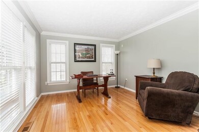 Leading from the entryway, the french doors open i