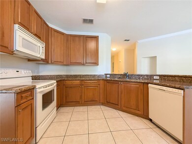 Kitchen with white appliances, brown cabinets, dar