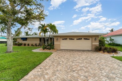Single story home with a garage and a front lawn