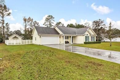 Ranch-style house with a front yard and a garage