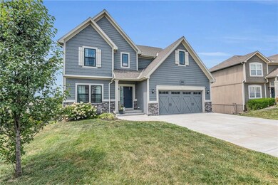 Craftsman inspired home with a garage and a front yard