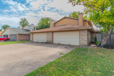 Brick siding, driveway, and each unit has a 2-car garage