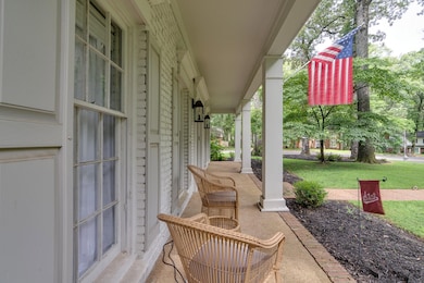Covered porch featuring a yard