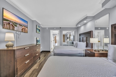 Bedroom featuring dark wood-style floors, baseboar