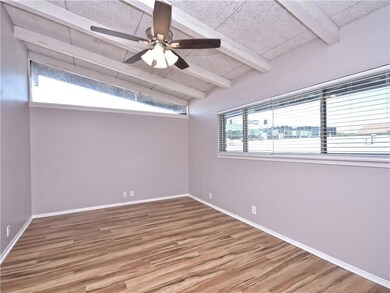 Unfurnished room featuring ceiling fan, baseboard