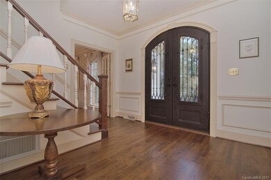 The foyer is presented with heavy crown moldings, 