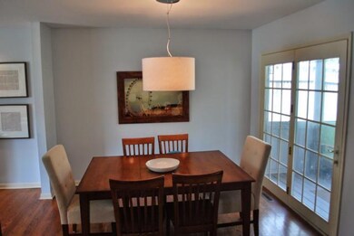 Dining area off kitchen with french doors to scree