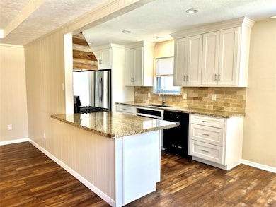Bright open kitchen featuring shaker cabinets with