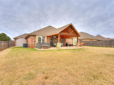 Back of property with large lawn and patio, hot tu