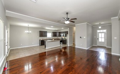 Unfurnished living room with ceiling fan with nota