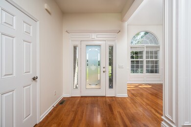 Notice the wood floors and upgraded trim work around front door and throughout