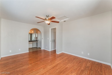 Bedroom with three windows, ceiling fan and light