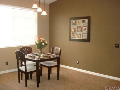 Formal dining room with wood blinds and hanging ch