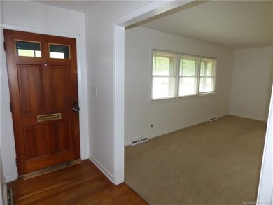 View of front door and opening to living room.  Pe