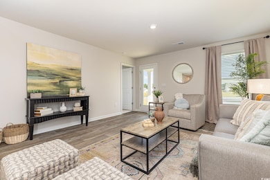 Living area featuring wood finished floors and recessed lighting