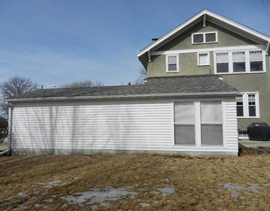 Exterior Back. attached garage and sunroom
