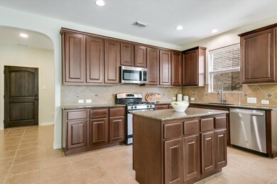 Kitchen featuring a kitchen island, stone counter