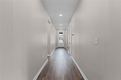 Entry hallway featuring guestrooms & passage to main living area