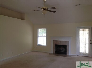 great room with vaulted ceiling, wood-burning fire