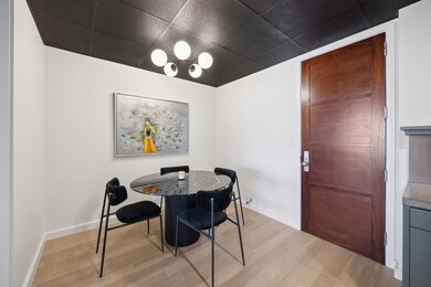 Dining space featuring a paneled ceiling, light wo
