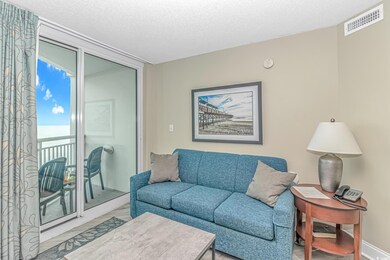 Living room featuring a textured ceiling and wood finished floors