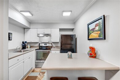 Kitchen featuring a sink, freestanding refrigerato
