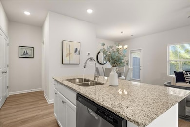 Kitchen featuring light wood finished floors, dish