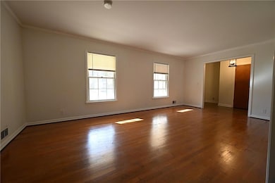 great room with ornamental molding and dark wood-t