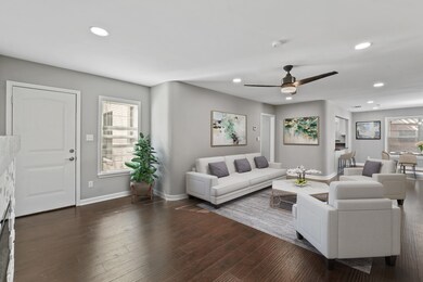 This lovely living room is open and bright! Featuring a ceiling fan, beautiful wood floors, an elegant mantle and fire place, large windows providing a beautiful view of the backyard and tons of natural light in throughout the day!