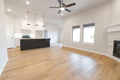 Kitchen with a fireplace, decorative light fixture