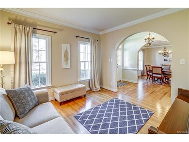Formal living room with hardwood floors and crown 