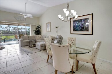 Tiled dining room featuring vaulted ceiling and ce