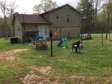 Back yard partially fenced for a play yard.