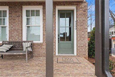 View of exterior entry featuring brick siding