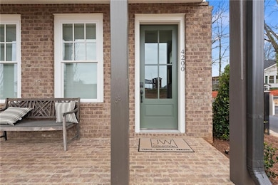 View of exterior entry featuring brick siding