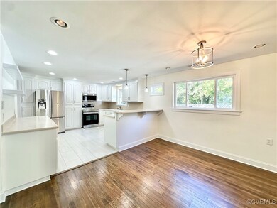 Kitchen featuring white cabinets, kitchen peninsul