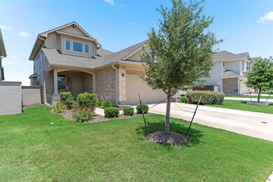 Craftsman-style home featuring concrete driveway,