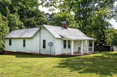 Exterior of farm house is comprised of wood siding.