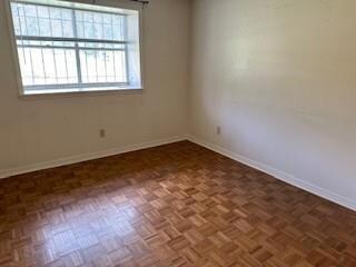 Bedroom featuring dark parquet flooring