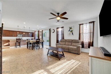 Living area featuring a ceiling fan and recessed l