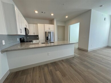Kitchen with kitchen peninsula, stove, sink, stain