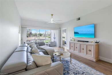 Living room with a ceiling fan, wood finished floo