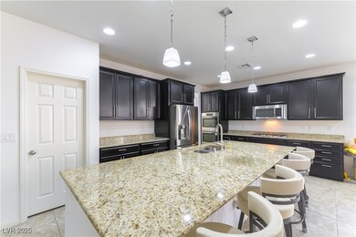 Kitchen with stainless steel appliances, a sink, l