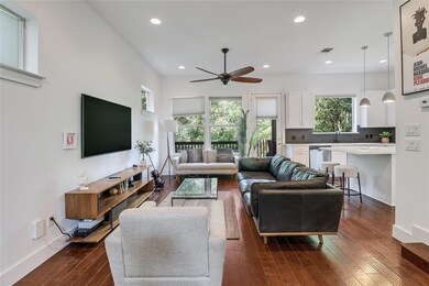 Living area with dark wood finished floors, ceili