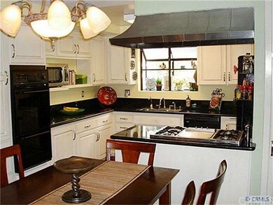 Kitchen has stainless cook top, hood and sink, dou