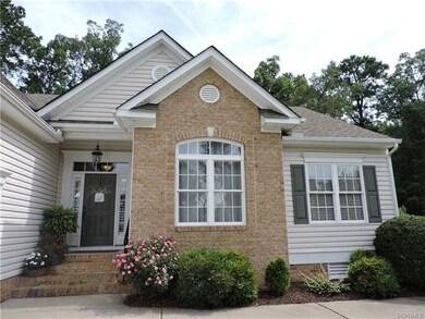 Welcoming brick accent and mature landscaping.