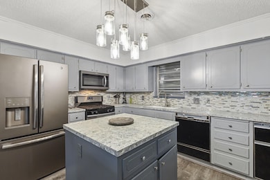 Kitchen featuring sink, decorative backsplash, app