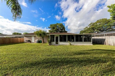 LARGE FENCED BACKYARD looking towards the back of home.  4-Season bonus room and easy access to garage through new rear door (left of photo).